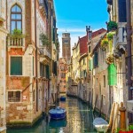Venice cityscape, water canal, campanile church and traditional buildings. Italy