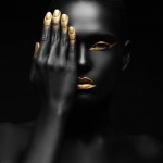 dark-skinned woman with golden make-up.